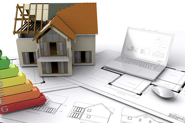 A model house with a laptop and mouse.